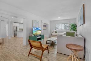 a living room with a couch and a table at Barefoot by the Bay at Bayside Bungalow in Anna Maria