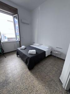 a bedroom with a bed with two towels on it at Residenza Margot Cosenza in Cosenza