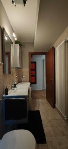 a bathroom with a sink and a toilet in a room at La Casa del Bosco in Filottrano