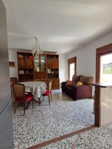 a living room with a table and a couch at Casa El Abeto in Fiscal +6 photos