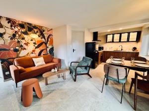 a living room with a couch and a table at Le Bohème, Très bel Appartement près de Rennes in Noyal-sur-Vilaine