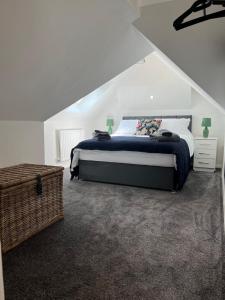 a bedroom with a king sized bed in a attic at Gatwick 2 Bed Apartment 4 in Horley