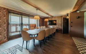 a dining room with a long table and chairs at La Tour de Contrôle - Chambres & Appartements in Challes-les-Eaux