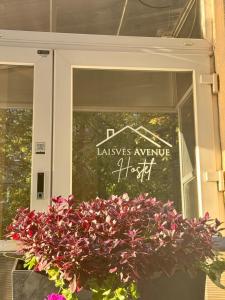 a sign in the window of avenue at Laisves Avenue Hostel "Easy Kaunas" in Kaunas