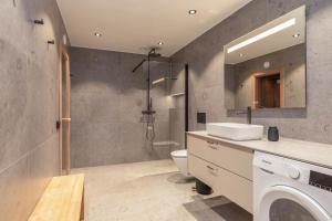 a bathroom with a sink and a toilet and a shower at Åre Travel - Holiday Village in Åre +42 photos