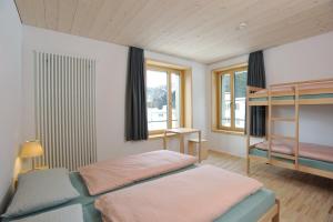 a bedroom with two beds and a window at St. Moritz Youth Hostel in St. Moritz +48 photos