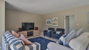 a living room with two couches and a flat screen tv at House Susan Pardew Hersham in Great Brak River +21 photos