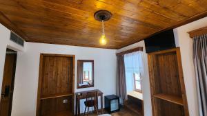 a living room with a wooden ceiling at Bizant House Boutique Hotel in Gjirokastër