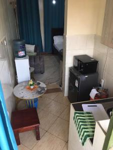 a small living room with a small table and a microwave at Affordable Comfort Stay Lumumba Drive,Nairobi in Nairobi
