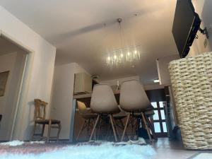a kitchen with chairs and a table with a television at Massone Climbing House - Holiday Home Garda Trentino in Arco +11 photos