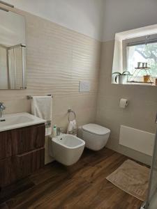a bathroom with a tub and a toilet and a sink at Villa S'Olia in Villa Gorizia +14 photos