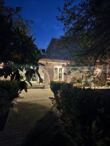 a white house with a pathway in front of it at Villa S'Olia in Villa Gorizia