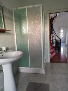 a bathroom with a sink and a walk in shower at Villa Ausilia in Saline Joniche +25 photos
