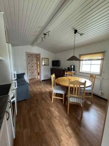 a kitchen and dining room with a table and chairs at Dundret 1 in Gällivare