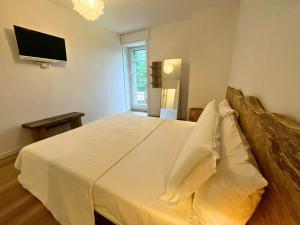 Ένα ή περισσότερα κρεβάτια σε δωμάτιο στο Appartamento Elegante con Servizi in oasi verde