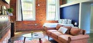 a living room with a couch and a bed at Jennifer's Historic Downtown Loft in Providence