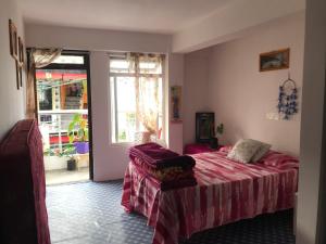 Postel nebo postele na pokoji v ubytování Naayuma Homestay