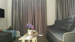a living room with a couch and a table with flowers at Thea Houses in Milina