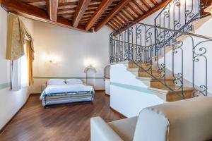 a bedroom with a staircase and a bed at Hotel Locanda Remedio in Venice
