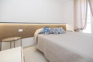 a bedroom with a bed with a blue pillow on it at Villa Irene Deluxe in Campofelice di Roccella +33 photos