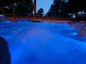 a swimming pool with blue water at night at Memita Mobile homes, Selce in Selce