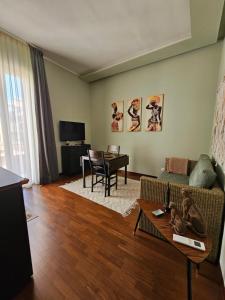a living room with a couch and a table at Pangea - Africa in Trani