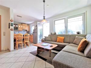 a living room with a couch and a table at Apartment Birkennest am Schluchsee in Schluchsee