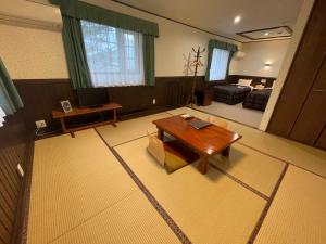 a living room with a table and a couch at 森のうた Morinouta Forest Stay in Nikko in Nikko +35 photos
