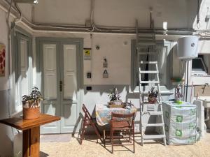 a room with a table and chairs and a ladder at the Lighthouse accommodation in Taranto