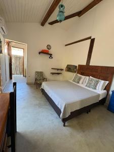 a bedroom with a large bed in a room at Gizele Sander Arte & Hospedagem in Ilhabela +78 photos