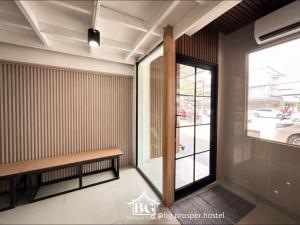 a waiting room with a bench and a window at BG prosper Hostel in Ban Don Muang (1)