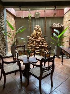 a patio with a table and chairs and a fire place at Negombo Boutique Villa in Negombo