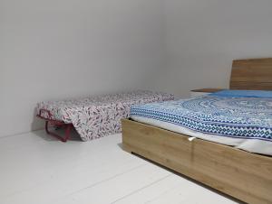 a bedroom with a bed with a wooden frame at A casa di Mary in Vieste