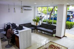 a person sitting at a desk with a computer at Terminal 27 Hotel in Hulhumale +9 photos