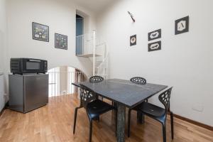 a dining room with a table and chairs and a tv at Single House in Pisa