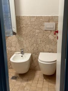 a bathroom with a toilet and a sink at Cairoli House- Grottammare in Grottammare +11 photos
