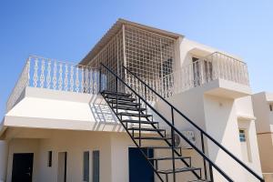 a spiral staircase on the side of a building at LakeView Penthouse Room Himayatnagar in Lingampalli