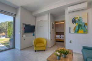 a living room with a blue couch and a yellow chair at Villa Maritini in Chania Town