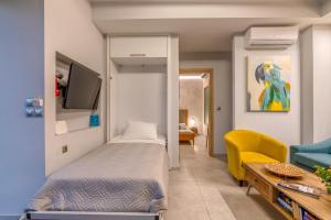 a bedroom with a bed and a tv and a couch at Villa Maritini in Chania Town +40 photos