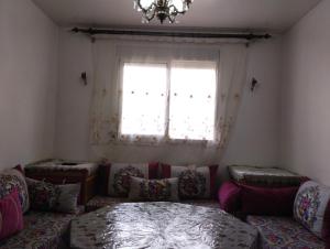 a living room with a couch and a window at Dar Yasmine 3 in Ifrane