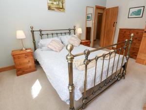 a bedroom with a bed with a metal frame at Bridge House in Hawes