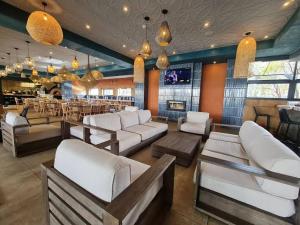 a lobby with white couches and a bar at Blyde Lagoon in Pretoria
