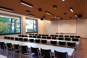 a conference room with a large white table and chairs at Zurich Youth Hostel in Zürich