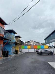 a car parked in a parking lot next to buildings at 69 Comfortainer Homestay in Taiping