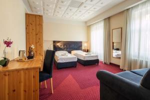 a hotel room with two beds and a desk at HOTEL AURONZO - outdoor basecamp in Auronzo di Cadore +61 photos