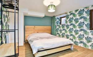 a bedroom with a bed and green walls at L’Alsacienne room et spa in Lautenbach +11 photos
