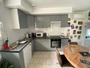 a kitchen with a table and a dining room at Domaine De Domingeal Meublé de Tourisme 3 étoiles in Saint-Germain-les-Vergnes +28 photos