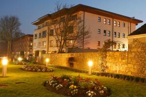 a garden with lights in front of a building at Annebrook House Hotel in Mullingar