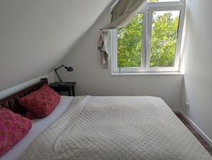 a bedroom with a bed with two pillows and a window at Oberdeck Ostsee in Klütz