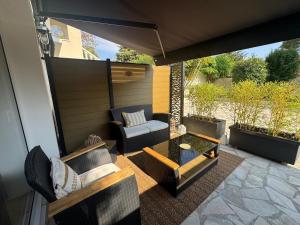 an outdoor patio with a couch and a table at Superbe 2P Terrasse Proche Plage à 2 min in Saint-Raphaël